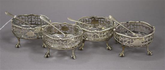 A set of four George II oval silver salts, London 1755, together with four silver salt spoons with shell bowls (8)